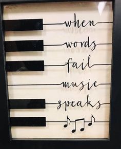 a framed musical poster with the words when words fail music speaks written on piano keys