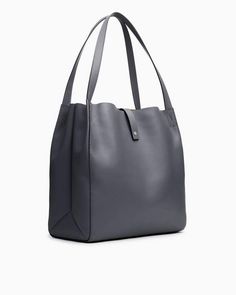 A highly versatile tote bag with contrasting straps, laptop compartment and pockets aplenty. 100% calf suede and leather trim. rag & bone Women's Large Tote Bag | Praline Suede Modern Hobo Bag With Leather Trim For Shopping, Modern Shopping Hobo Bag With Leather Trim, Luxury Hobo Bag With Gunmetal Hardware In Tote Shape, Luxury Hobo Bag With Gunmetal Hardware, On-the-go Satchel With Leather Trim And Double Handle, Leather Trim Bucket Satchel, Leather Trim Bucket Shoulder Bag For On-the-go, Modern Bucket Bag With Leather Trim Tote, Modern Bucket Bag With Leather Trim