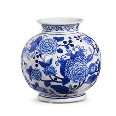 a blue and white vase with flowers on it