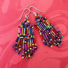 These earrings are a smaller version of the longer stunning Confetti Frings Earrings b Seed bead fringe dangle earrings made with mirror bright metallic bugle beads and multicolored 11/0 seed beads. The earrings have sterling silver plated earwires. These earrings are small in size with big, bold colors. They measure 2.5 inches long (6.35cm). Perfect anytime and stunningly chic. All items are handmade and shipped promptly. Please allow extra time when ordering multiple items. Thanks for looking Colorful Tiny Beads Dangle Earrings, Multicolor Chandelier Earrings With Ear Wire As Gift, Colorful Dangle Earrings With Tiny Beads, Multicolor Beaded Drop Earrings For Pierced Ears, Rainbow Dangle Earrings With Tiny Beads, Multicolor Drop Beaded Earrings For Pierced Ears, Multicolor Czech Glass Dangle Earrings, Multicolor Long Drop Jewelry With Tiny Beads, Rainbow Beaded Drop Earrings With Dangling Beads