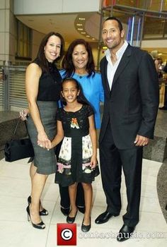 a man and two women standing next to each other in front of a lobby area