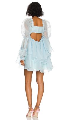 Find SELKIE X The Moonlight Dress In Baby Blue on Editorialist. Selkie x REVOLVE The Moonlight Dress in Baby Blue. - size 5X (also in 6X, XXS) Selkie x REVOLVE The Moonlight Dress in Baby Blue. - size 5X (also in 6X, XXS) 100% polyester. Made in China. Dry clean only. Fully lined. Hidden back zipper closure. Ruched bust. Puff sleeves Lightweight organza fabric with ruffle trim. SLKR-WD78. SKPO1104. Meet Selkie: fanciful, nostalgic and extra romantic. Started by former Wildfox Co-Founder Kimberle Ethereal Ruffled Dress For Party, Light Blue Organza Dress With Ruffles, Summer Organza Mini Dress With Sheer Sleeves, Ethereal Flowy Party Dresses, Sheer Ethereal Spring Dresses, Ethereal Sheer Dresses For Spring, Ethereal Fitted Organza Dresses, Summer Fairy Party Dress In Organza, Summer Party Fairy Dress In Organza