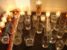 many glasses and candles are on the table