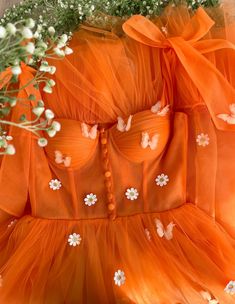 Details:- Orange tulle- Corset with built-in pads and rigilene boning- Cinched waist  - Decorative placket and wide bow straps - Embellished with embroidered daisies and butterflies- Tea-length style with a gathered hem and a mini underskirt. Floral Hoco Dress, Prom Dress With Pockets, Burgundy Prom Dress Long, Cheap Wedding Dress Boho, Cheap Lace Wedding Dresses, Prom Evening Dresses, Fleurs Diy, Beach Wedding Dress Boho, Prom Dresses With Pockets