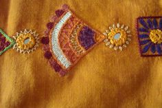 an embroidered piece of cloth with different designs on it