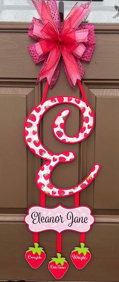 the front door is decorated with pink and red decorations, including a large number sign