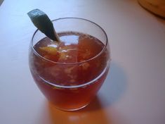 a glass filled with liquid sitting on top of a table