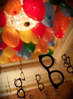 the ceiling is decorated with balloons and scissors