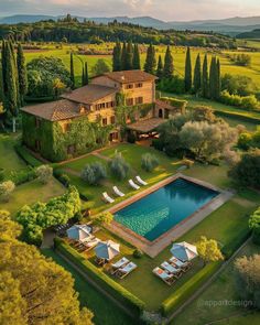 an aerial view of a large house with a swimming pool in the middle of it