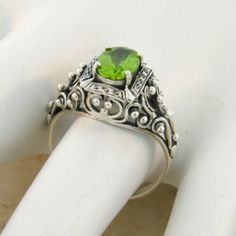 Vintage Estate 1.50 Carat Natural Peridot Solitaire Filigree Ring. Heart Designs. 925 Solid Sterling Silver. The Top Of The Ring Measures Nearly 1/2 Inch In Length. Set With One High Quality 8x6 mm, Approx. 1.50 Ct. Natural Peridot Stone. Stamped 925. Excellent Condition/Like New. Classic Silver Peridot Rings, Classic Silver Ring With Peridot, Green Rings With Intricate Design For Gift, Peridot Rings Stamped 925 For Anniversary, Heirloom Style Green Filigree Ring As Gift, Green Oval Filigree Ring In Sterling Silver, Green Rings With Intricate Design, Heirloom Sterling Silver Green Ring, Green Rings With Intricate Design For Promise