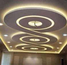 the ceiling in this room is decorated with circular lights and circles on top of it