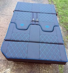 a large blue piece of luggage sitting on the ground