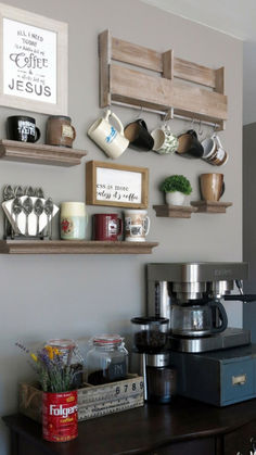 a coffee bar with shelves and cups on the wall above it, along with other items