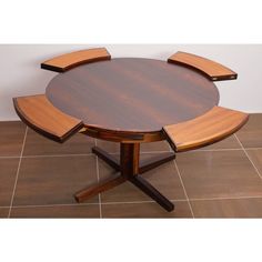 a wooden table sitting on top of a tiled floor