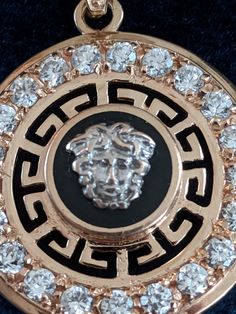 "A well made 14 karat rose gold jewelry ensemble consisting of a pendant with matching earrings for pierced ears set with cubic zirconia. The exception is a .07 carat diamond at the top of the pendant's bail, a replacement stone. The neo-classical design features Greek fret work and 14k white gold lion's faces on top of black onyx rounds. The CZ stones are .05 carats each in the pendant and .03 in the earrings. The pendant measures 1 9/16 inches high, including the bail; it is 1 1/8 in diameter. Gold Lion, Pendant Bails, Rose Gold Pendant, Rose Gold Jewelry, Cz Stone, Earings Piercings, Matching Earrings, Gold Pendant, Ear Piercings