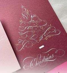 two christmas cards with the word merry written in white ink on red and pink paper