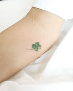 a small four leaf clover tattoo on the foot