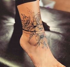 a woman's foot with flowers on it