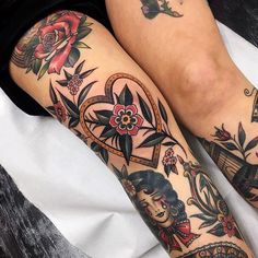 two women with tattoos on their legs sitting next to each other