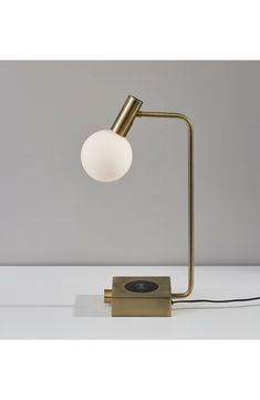 a lamp that is sitting on top of a table next to a light bulb and some wires