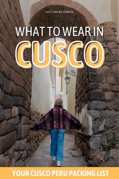 a woman walking down an alley way with the text what to wear in cusco your cusco peru packing list