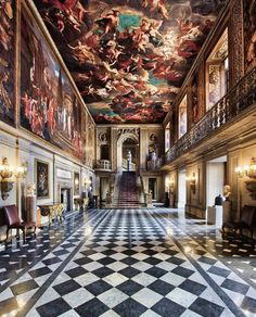 an ornate hallway with paintings on the ceiling