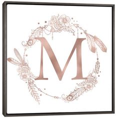 the letter m with flowers and feathers on it is shown in rose gold foil lettering