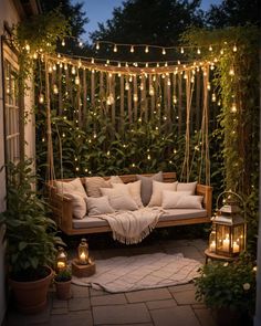 an outdoor seating area with lights strung over it