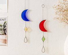 three colorful wind chimes hanging on the wall