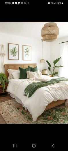 a bed with white sheets and green pillows