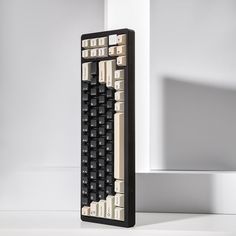 a black and white keyboard sitting on top of a table