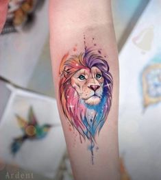 a colorful lion tattoo on the arm