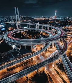 an aerial view of a highway intersection at night