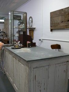 an old fashioned kitchen island in the middle of a room