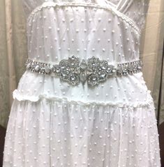 "A unique geometric bridal sash, inspired by Art Deco 1920s Gatsby wedding style. This wedding belt is made of top grade rhinestone crystals and simulated cat's eye gemstones, set onto a tie-back double-sided satin ribbon base, plus more crystals at both ends for added blings. Sash total length (crystal plus ribbon) is 78\" or 200cm. Crystal is about 19 1/2\" (49.5cm) long, 2 1/8\" (5.4cm) wide. Ribbon is 1\" (2.5cm) wide. View all sash belts at https://etsy.me/1aLToLU" White Wedding Dress With Sashes, White Gatsby Style Wedding Dress, White Gatsby Wedding Dress, Silver Vintage Wedding Dress, Elegant White Sashes For Mother Of The Bride, Elegant White Sash For Mother Of The Bride, Vintage Silver Wedding Dress, Fitted Sashes Bridal Belt For Wedding, Fitted Bridal Belt With Sashes For Wedding