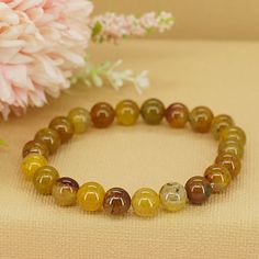 Known for its captivating patterns and sunny hues, yellow dragon vein agate is a stone of joy, confidence, and personal power. It radiates warmth and positivity, helping to dispel negativity and attract abundance and success into your life. * High-Quality Beaded Bracelet* Unisex Bracelet* 8mm beads* Made to Fit Your Wrist or Anklet* Made with Pure Positive Energy* Great Gift for Everyone Spiritual Amber Agate Bracelets, Yellow Spiritual Crystal Bracelet, Yellow Bracelets With Natural Stones, Yellow Spiritual Bracelets As Gift, Yellow Spiritual Bracelet With Gemstone, Spiritual Yellow Bracelets For Gift, Yellow Natural Stones Round Bracelets, Yellow Spiritual Crystal Bracelet Gift, Spiritual Yellow Beaded Bracelets