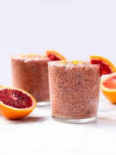 two glasses filled with oatmeal and blood oranges next to each other