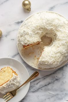 a piece of cake on a plate with a fork next to it and another slice missing