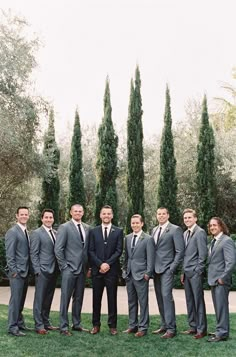 a group of men in suits standing next to each other