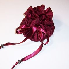 a red satin bow on a white table