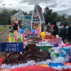 there are many items on the table at this event that is decorated with balloons and streamers