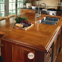 a kitchen island with a cutting board and vegetables on it