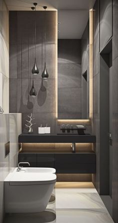 a bathroom with a bathtub, sink and lights hanging from the ceiling above it