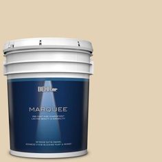 a bucket of behr marquee paint on a beige background with the lid open