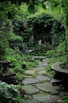 a stone path in the middle of a lush green garden