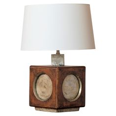 a lamp that is sitting on top of a wooden block with two circles around it