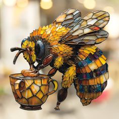 a stained glass bee drinking from a cup