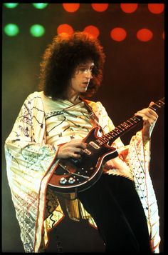 a man with an electric guitar on stage