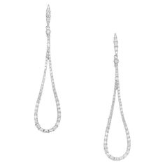 Elegant Loop shaped dangle diamond earrings. Comprised of 16 single cut diamonds totaling .90cts, set in 14k white gold loop style settings. 1.8 inches long diamond dangle drop earrings. Follow us on our 1stDibs storefront to view our weekly new additions and 5 Star Reviews at Peter Suchy Jewelers. 16 single cut diamonds, G-H SI approx. .90cts 14k white gold Stamped: 14k 3.6 grams Top to bottom: 46.0mm or 1.8 inch Width: 10.5mm or .41 Inches Depth or thickness: 1.9mm Luxury White Gold Long Drop Earrings, White Brilliant Cut Dangle Diamond Earrings, Luxury Diamond White Drop Linear Earrings, Luxury White Clip-on Diamond Earrings, Luxury White Diamond-cut Chandelier Earrings, Diamond Dangle Earrings, Gold Earrings Dangle, Vintage Earrings, Diamond White