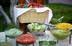 a table topped with bowls filled with different types of salads and condiments